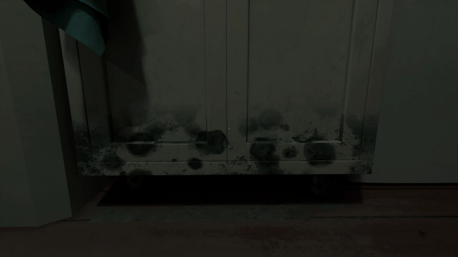 Black mold spreading along a kitchen cabinet after an inspection sticker is peeled away in PROPERTY INSPECTION.